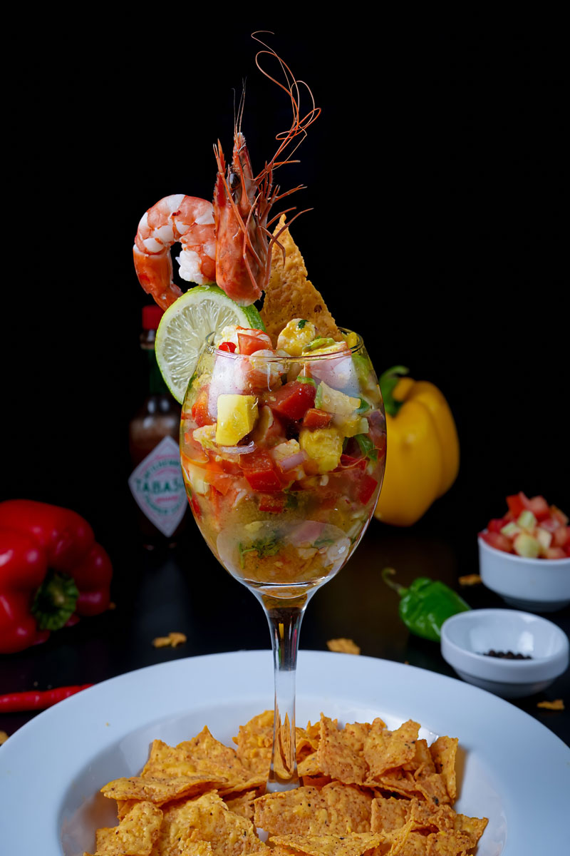 Spicy shrimp ceviche cocktail with Tabasco sauce and tortilla chips