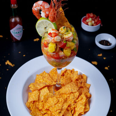 Tropical shrimp ceviche cocktail served with spicy tortilla chips