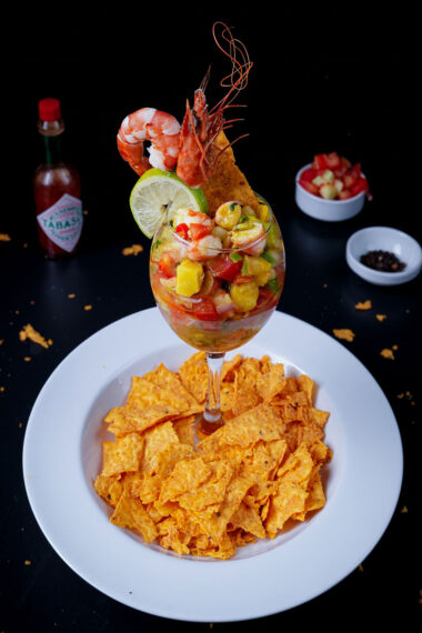 Tropical shrimp ceviche cocktail served with spicy tortilla chips