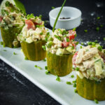 Elegant plating of Green Papaya Salad with lime and pepper garnish