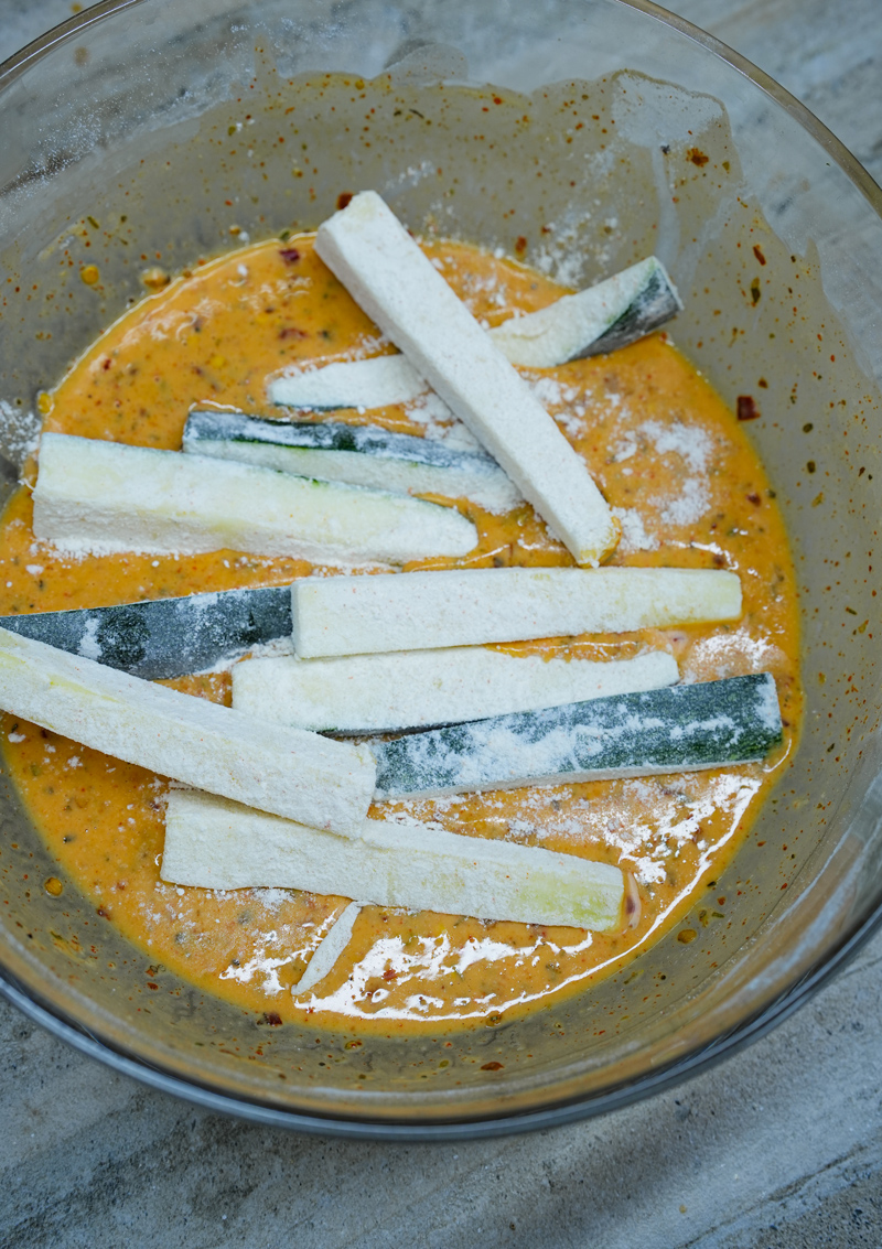 Zucchini sticks dipped in seasoned batter.