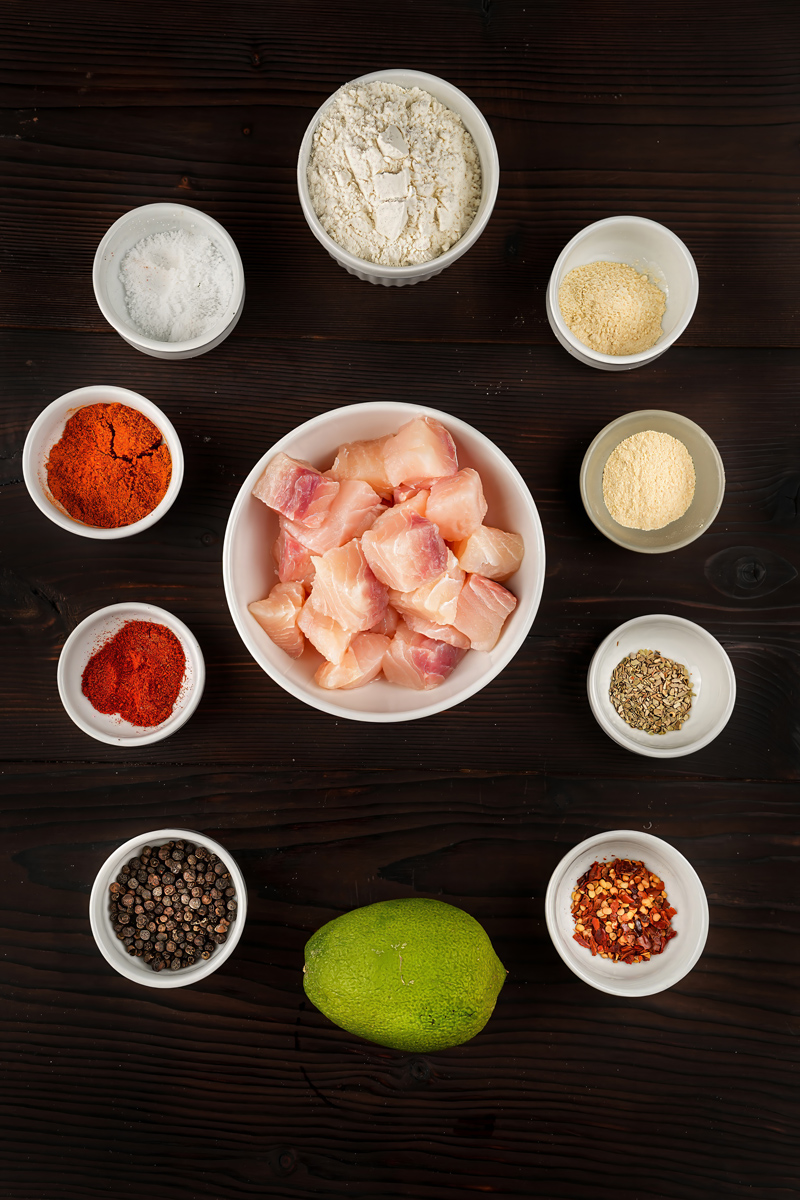 Raw fish pieces and spices prepared for Fish Popcorn recipe.