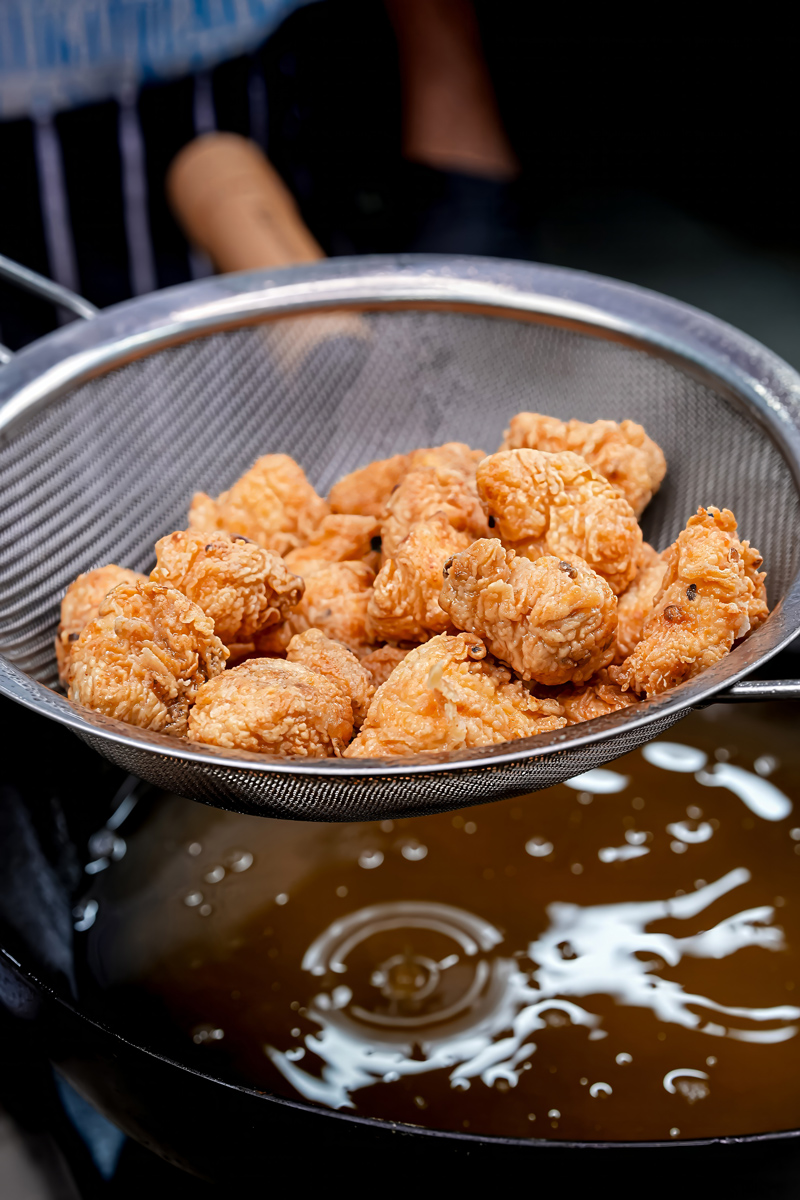 Fried Fish Popcorn being drained after deep frying.