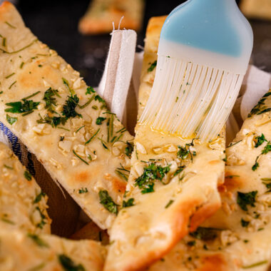 Final display of garlic naan with garnish and soft texture.