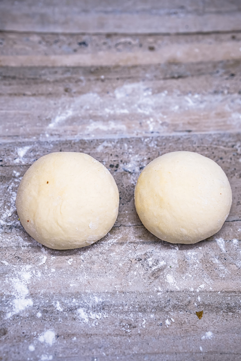 Dough balls for homemade garlic naan preparation.