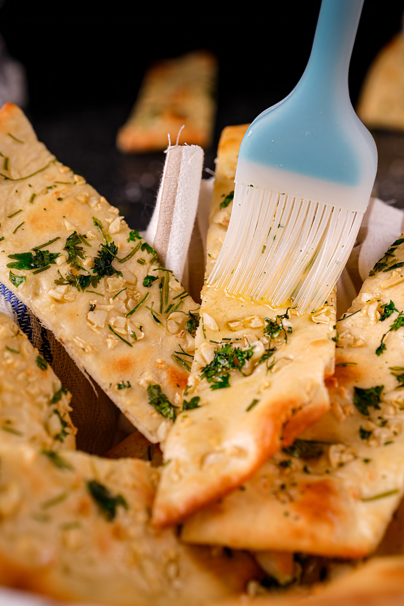 Final display of garlic naan with garnish and soft texture.