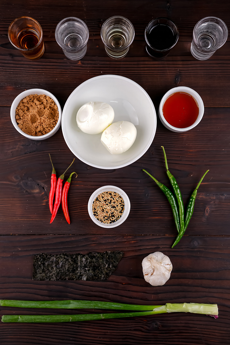 Ingredients for Mayak Eggs recipe on a dark wooden table.