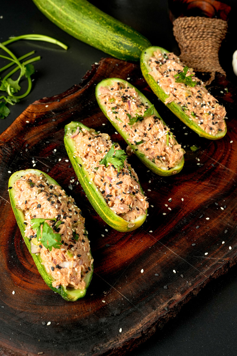 Keto-friendly tuna cucumber boats garnished with cilantro leaves