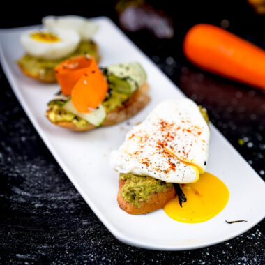 Avocado toast flight featuring poached egg and vegetable toppings