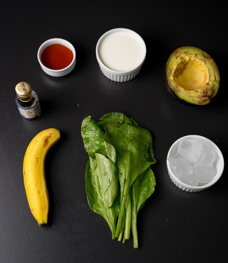 Avocado spinach smoothie ingredients - banana, spinach, avocado, milk and honey
