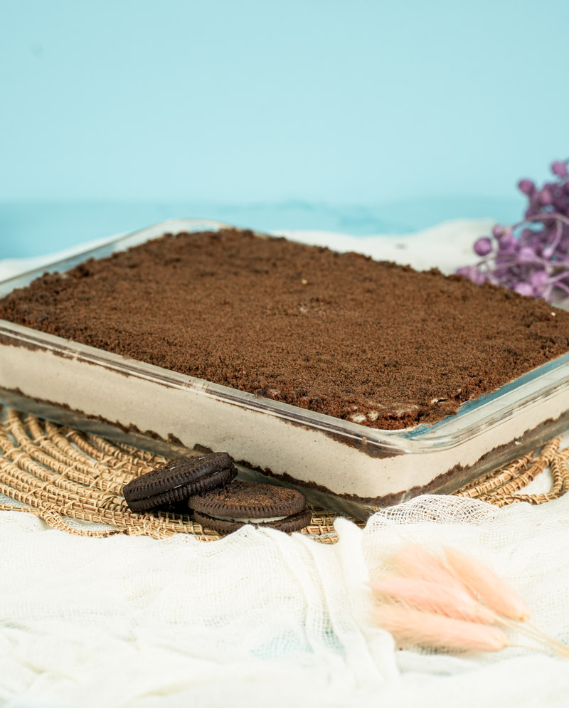 Finished Oreo dirt cake in rectangular dish with chocolate cookie crumble