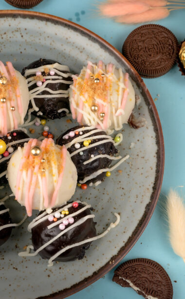 Overhead view of Oreo balls with colorful sprinkles on speckled plate