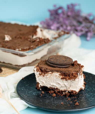 Individual serving of Oreo dirt cake with cookie on top