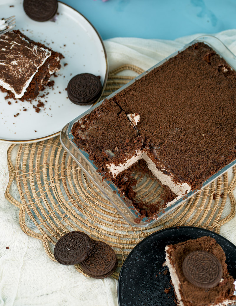 Sliced Oreo dirt cake with chocolate cookie crumbs and creamy filling