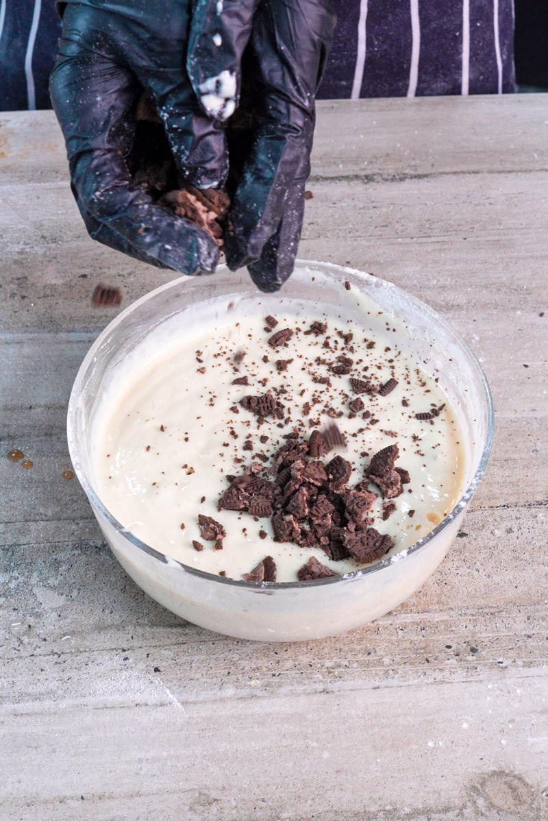 Adding crushed Oreos to pancake batter mixture