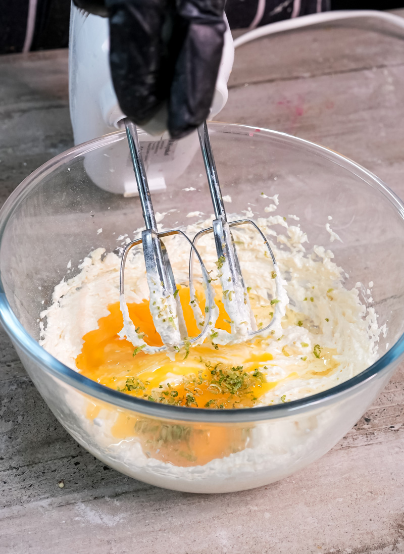 Adding herbs to Madeira cake mixture with electric beaters