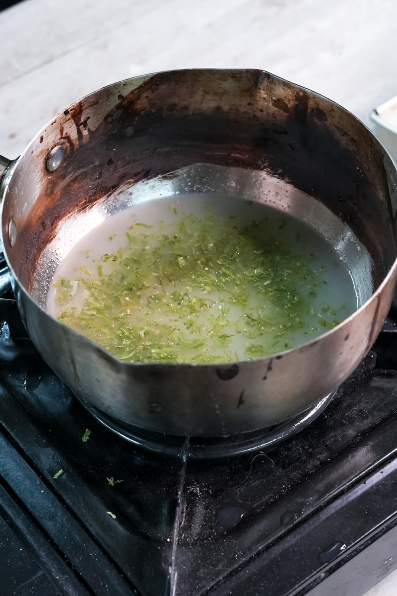 Adding lemon juice to zest mixture in saucepan for lemon curd"