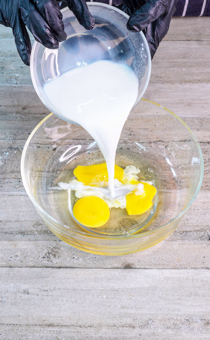 Adding milk to eggs for pancake batter mixture