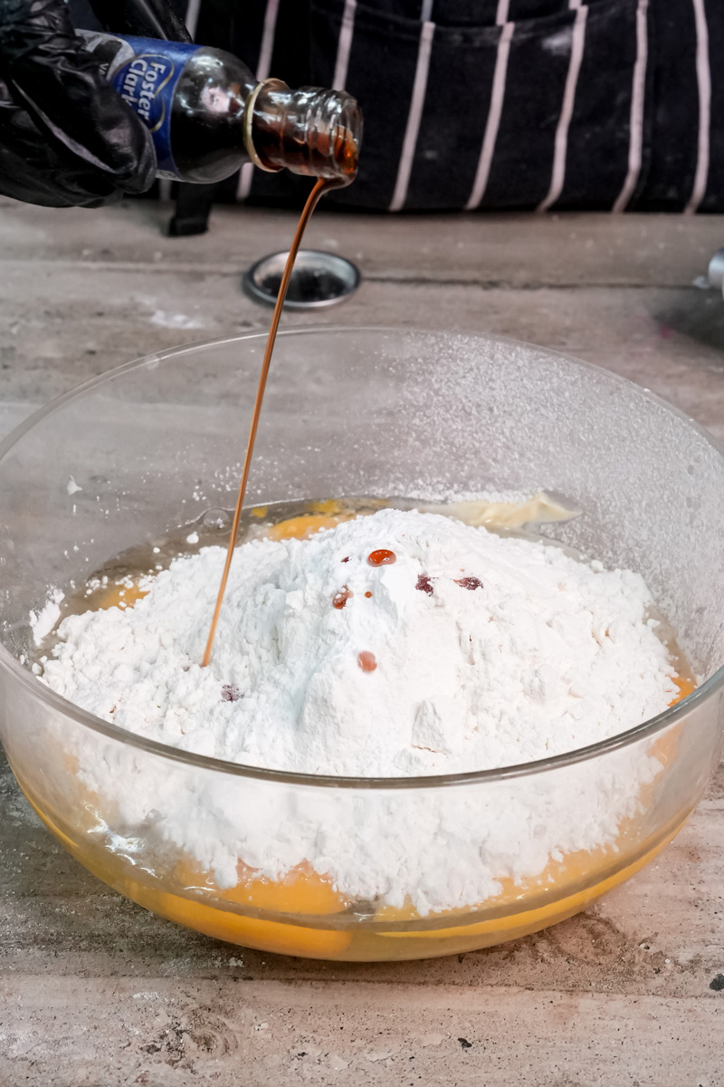 Adding vanilla extract to Battenberg cake mixture