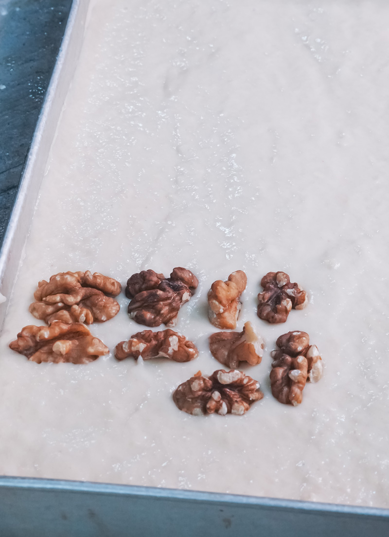 Adding walnut halves to sheet pan pancake batter