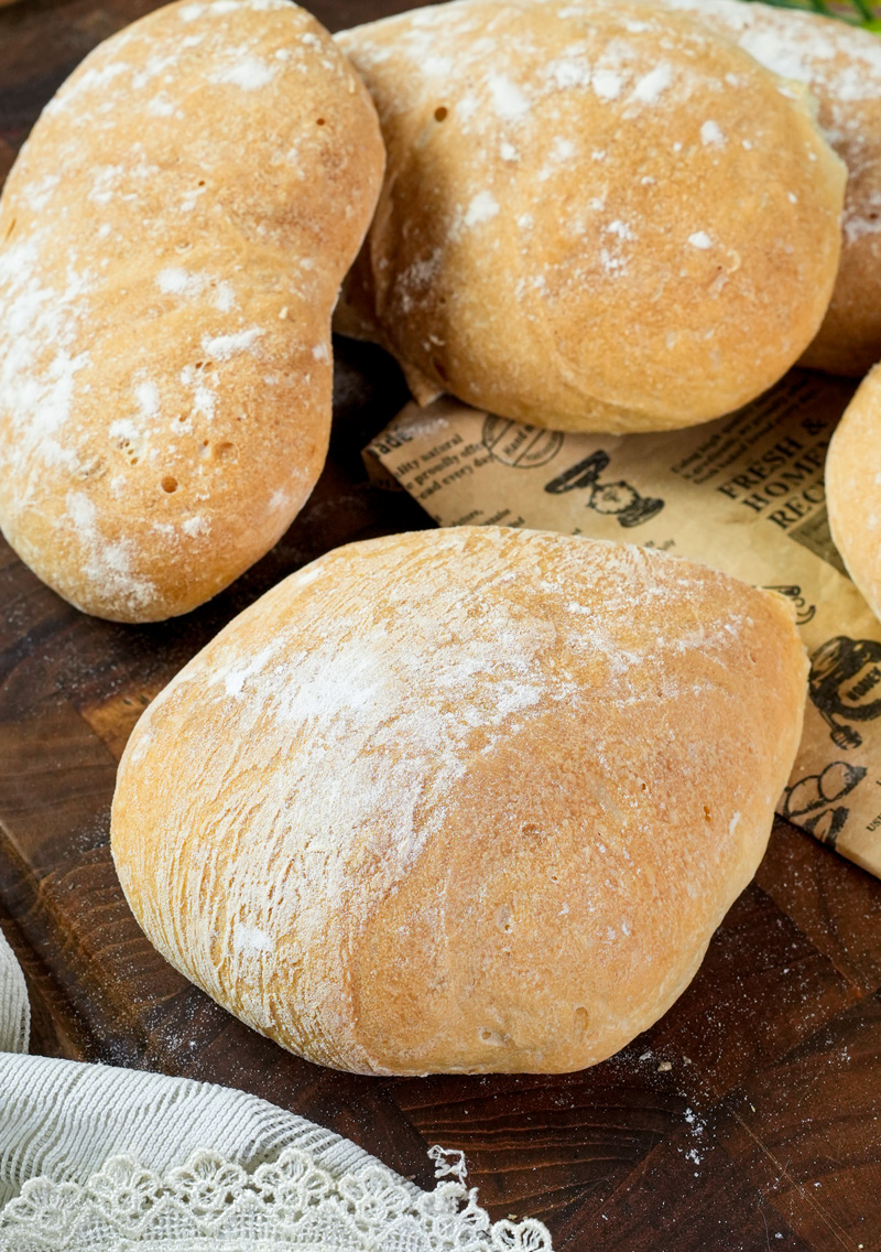 Artisan ciabatta bread loaves on wooden surface