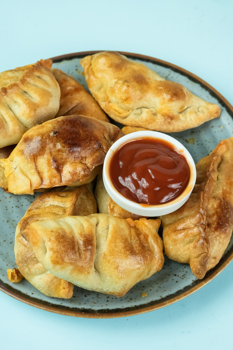 Baked chicken empanadas served with dipping sauce