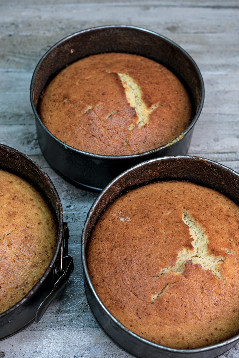 Baked churro cake layers cooling in springform pans