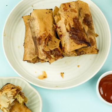 Banana lumpia with dipping sauce on mint background