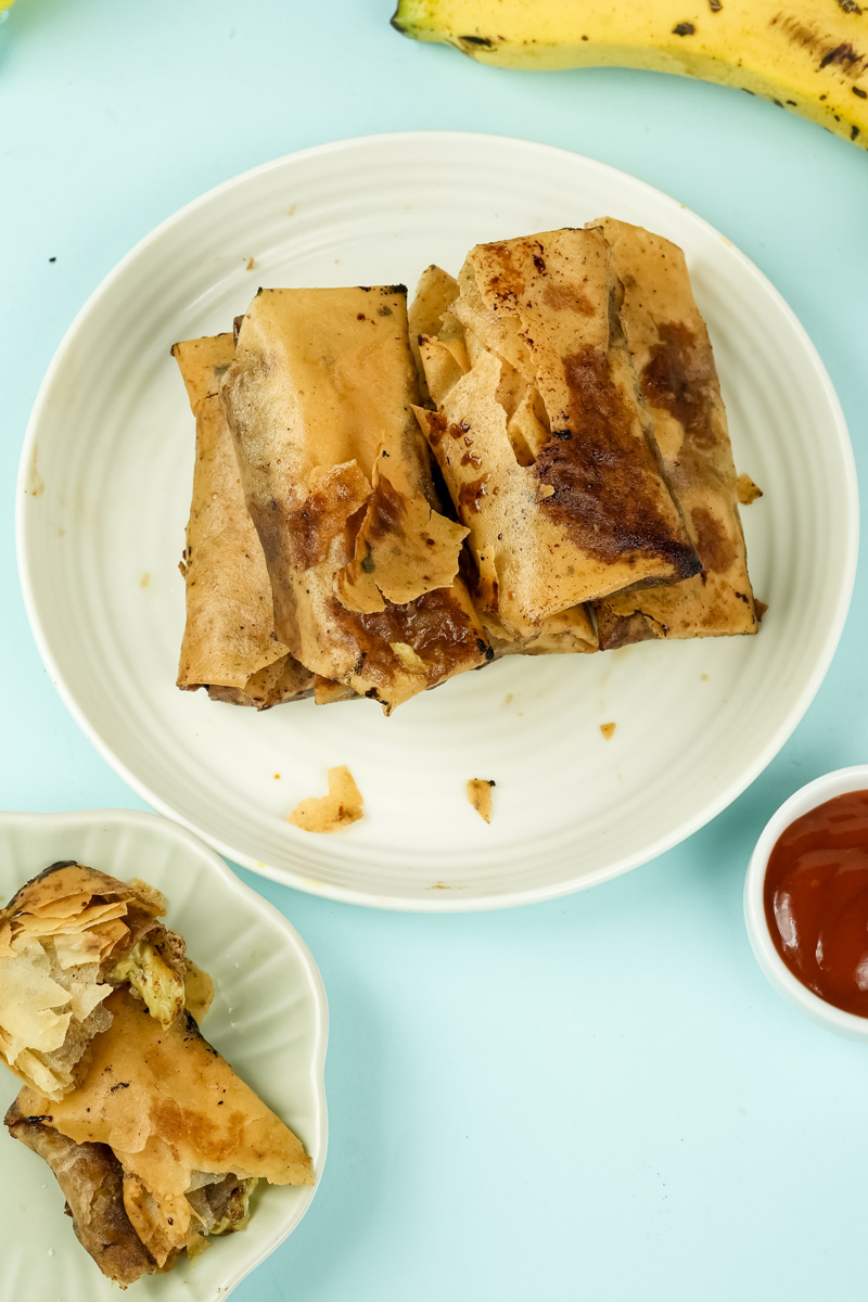 Banana lumpia with dipping sauce on mint background
