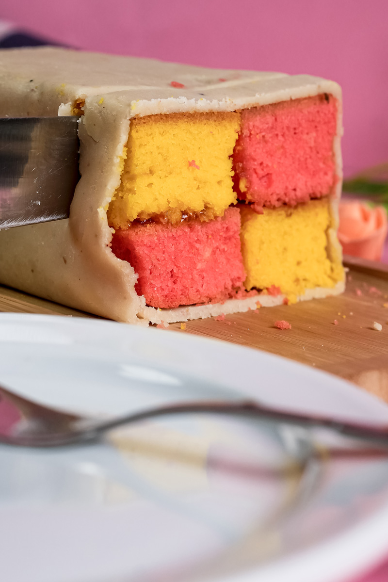 Close-up of Battenberg cake cross-section showing alternating colored squares