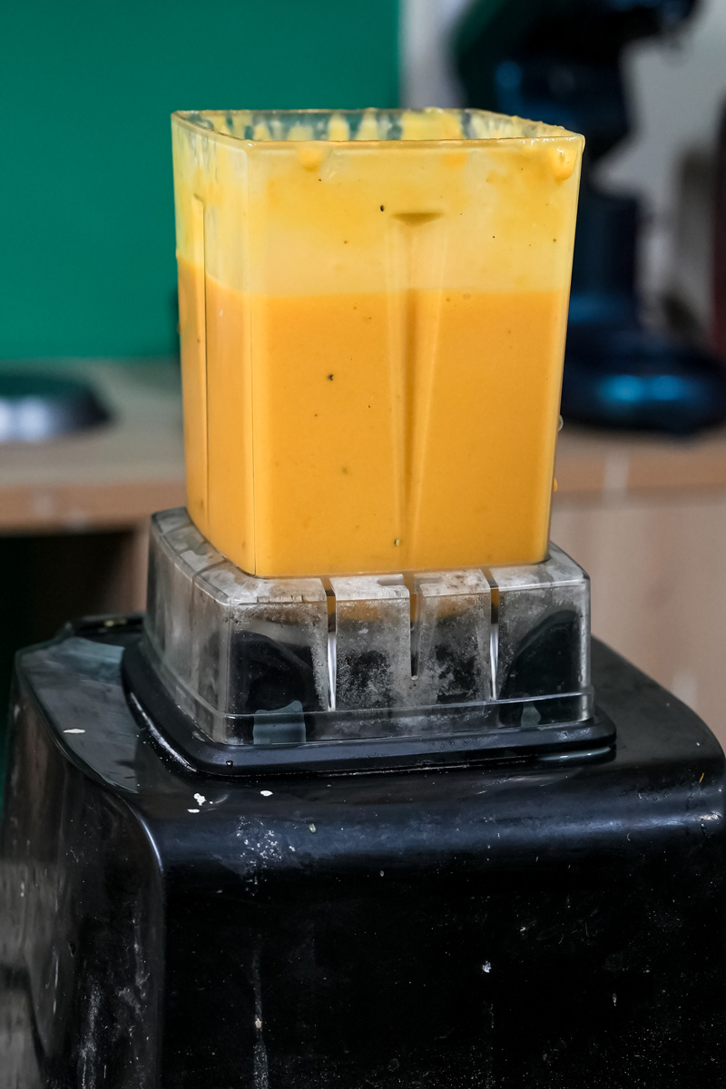Blended mango lassi mixture in blender jar