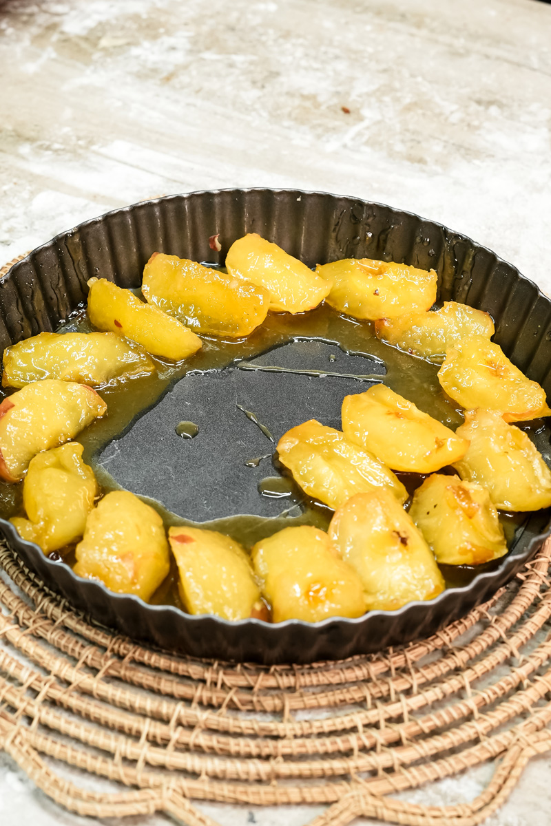 Caramelized apples filling entire tart pan for French Tarte Tatin