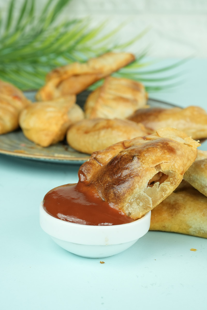 Chicken empanada cut open showing filling with sauce