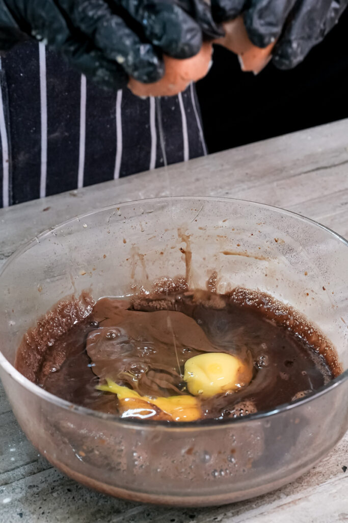 Chocolate pancake batter with eggs being mixed