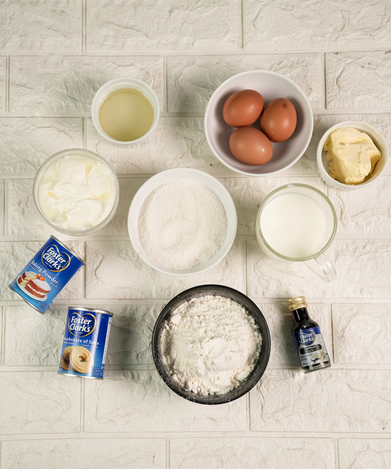 Churro cake ingredients including eggs, flour, milk, butter and baking essentials