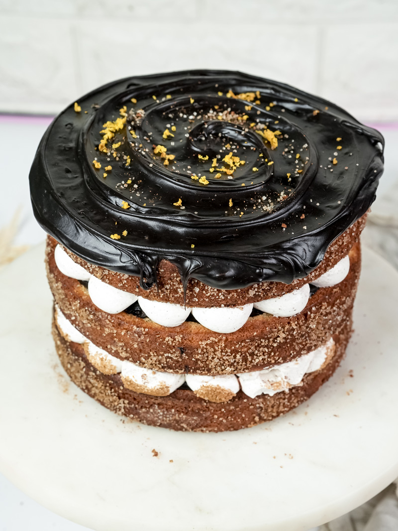 Churro cake top view showing chocolate ganache swirl with gold sprinkles decoration