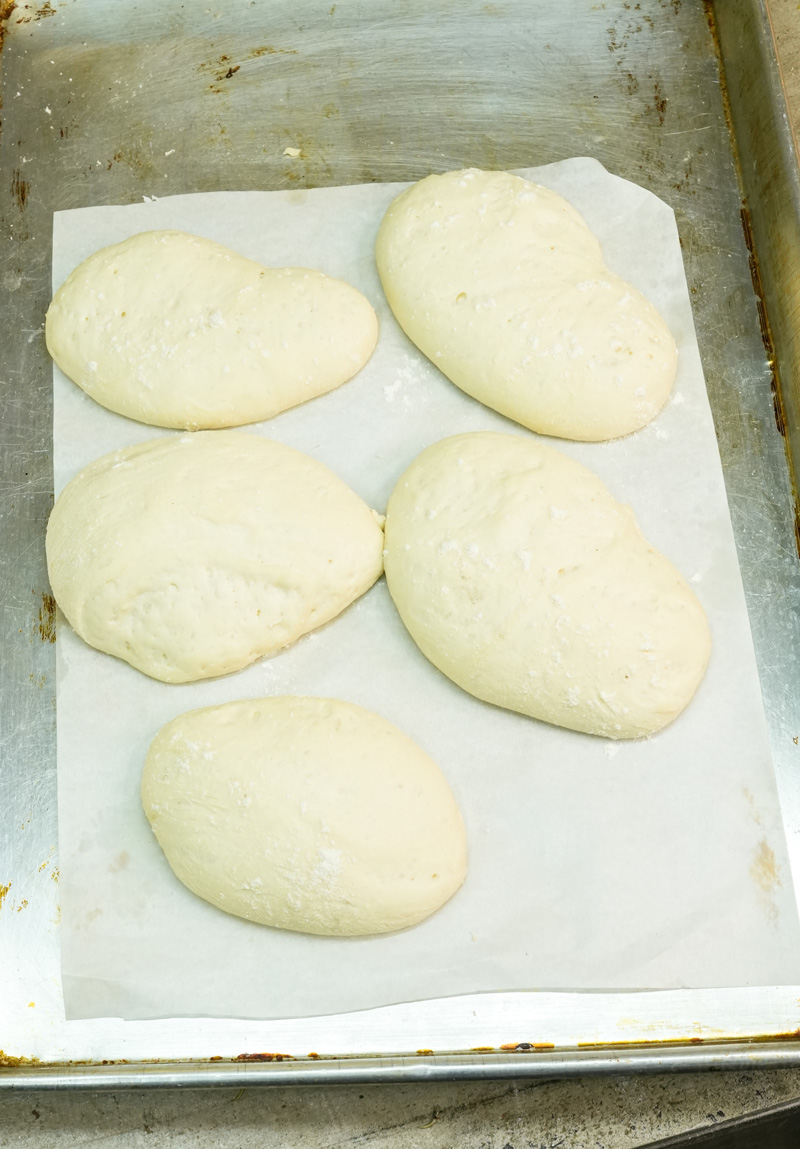 Ciabatta loaves on baking sheet ready for final rise