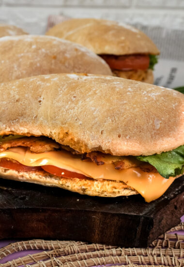 Ciabatta sandwich cross-section showing cheese and bacon layers