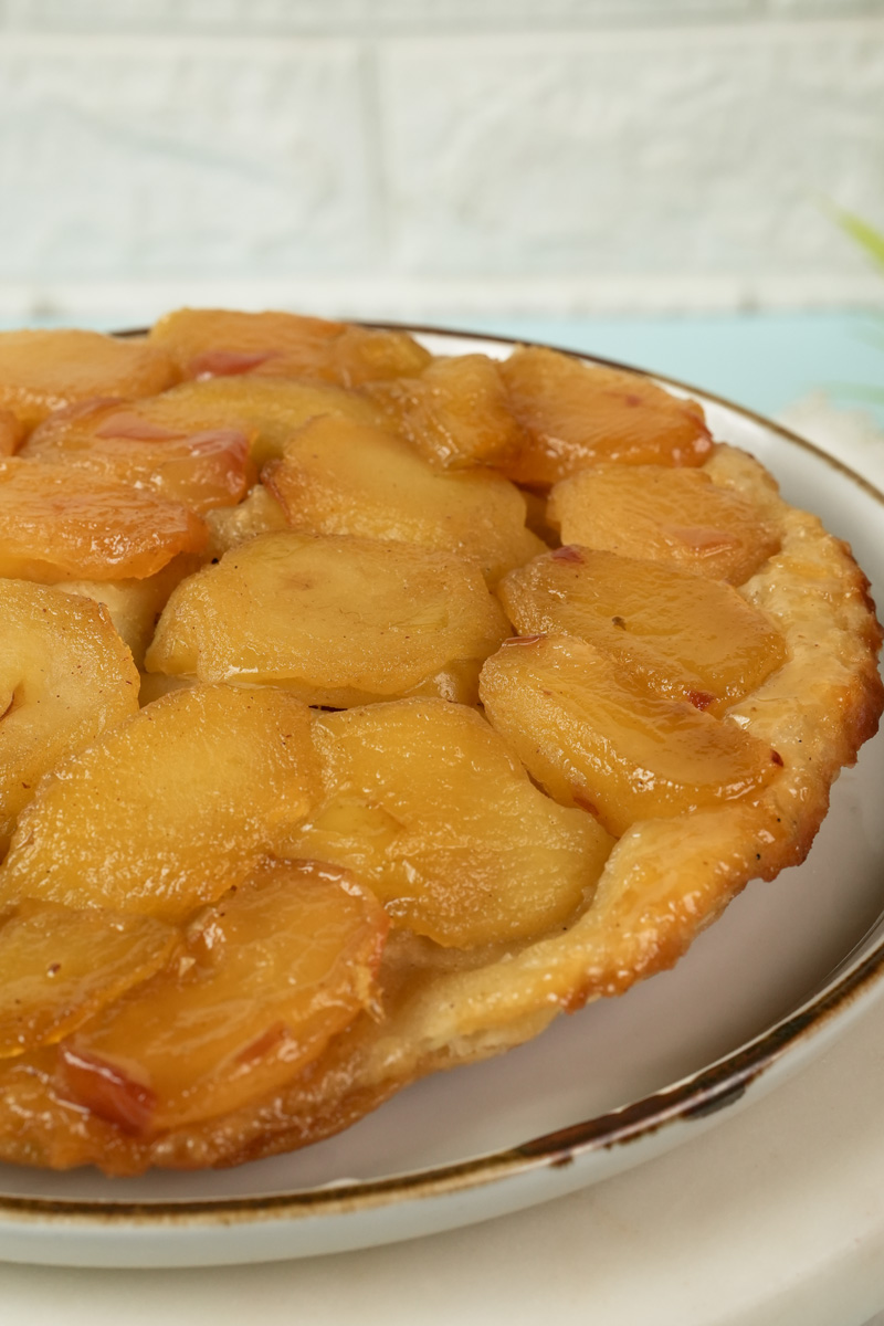 Classic French Tarte Tatin with caramelized apples on serving plate