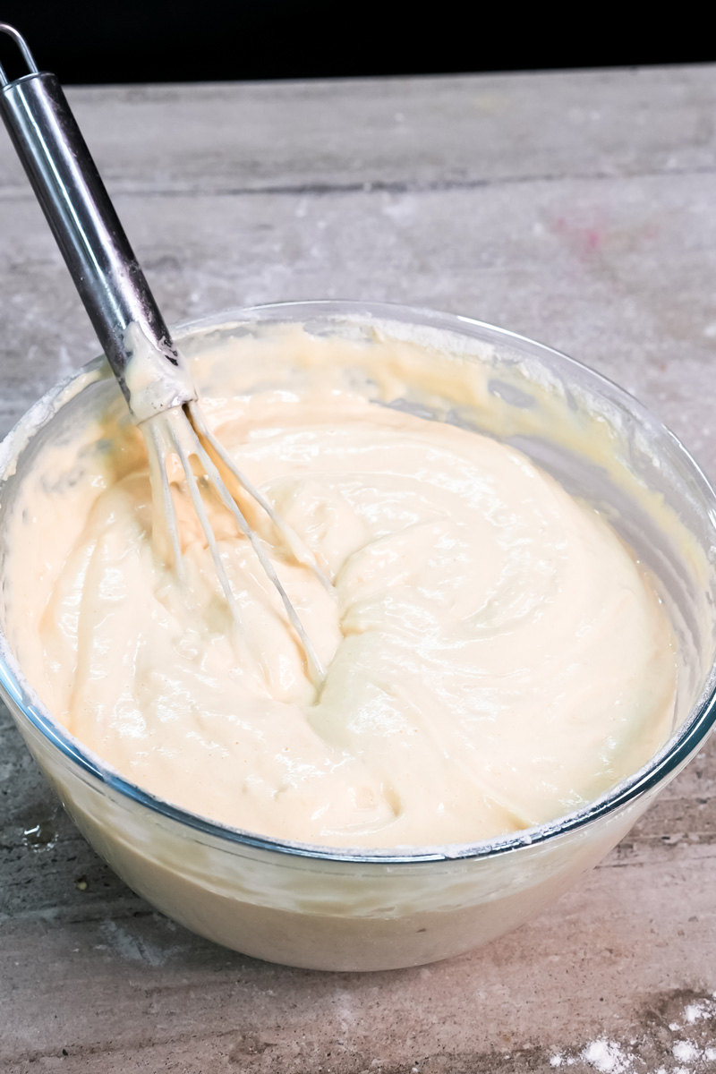 Creamy ladyfinger batter being whisked to perfect consistency