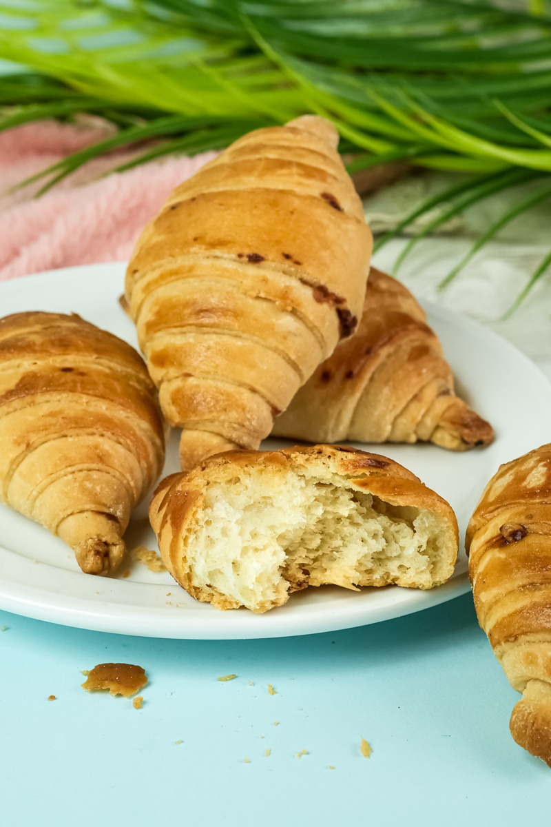 Croissant bread cut in half showing fluffy crumb structure