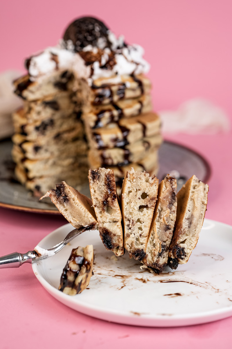 Cross-section of Oreo pancakes revealing cookie chunks throughout