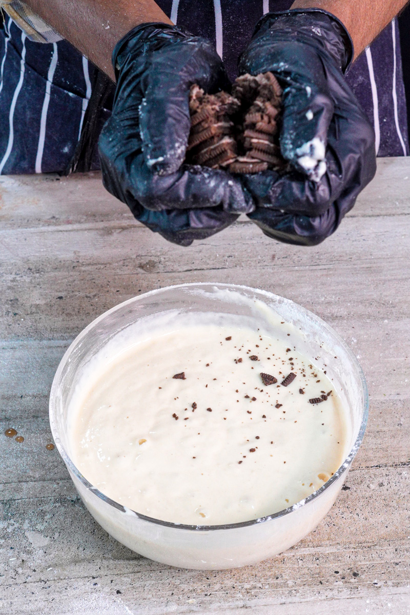 Crushing Oreo cookies for pancake batter preparation
