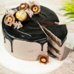 Cut Ferrero Rocher cake showing internal chocolate sponge layers