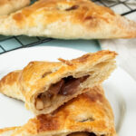 Cut apple turnover revealing tender spiced apple pieces inside