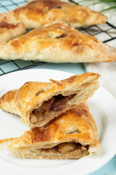 Cut apple turnover revealing tender spiced apple pieces inside