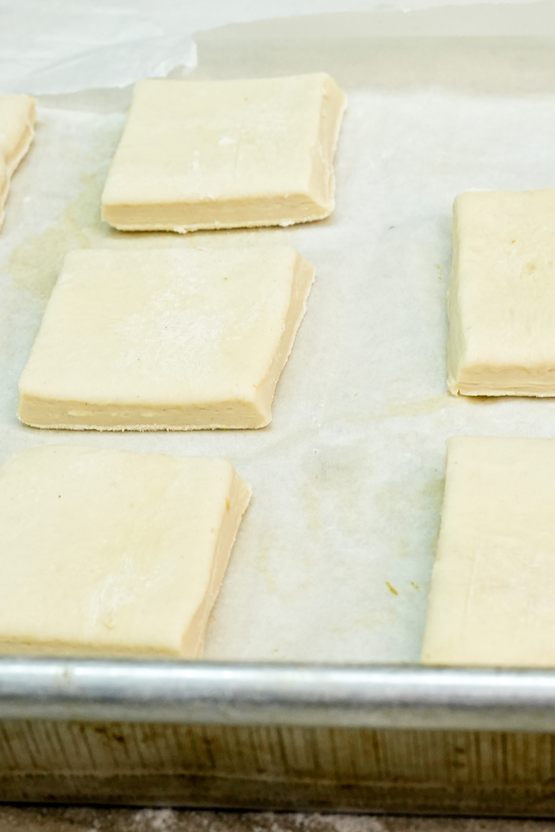 Cut puff pastry squares on baking sheet before baking