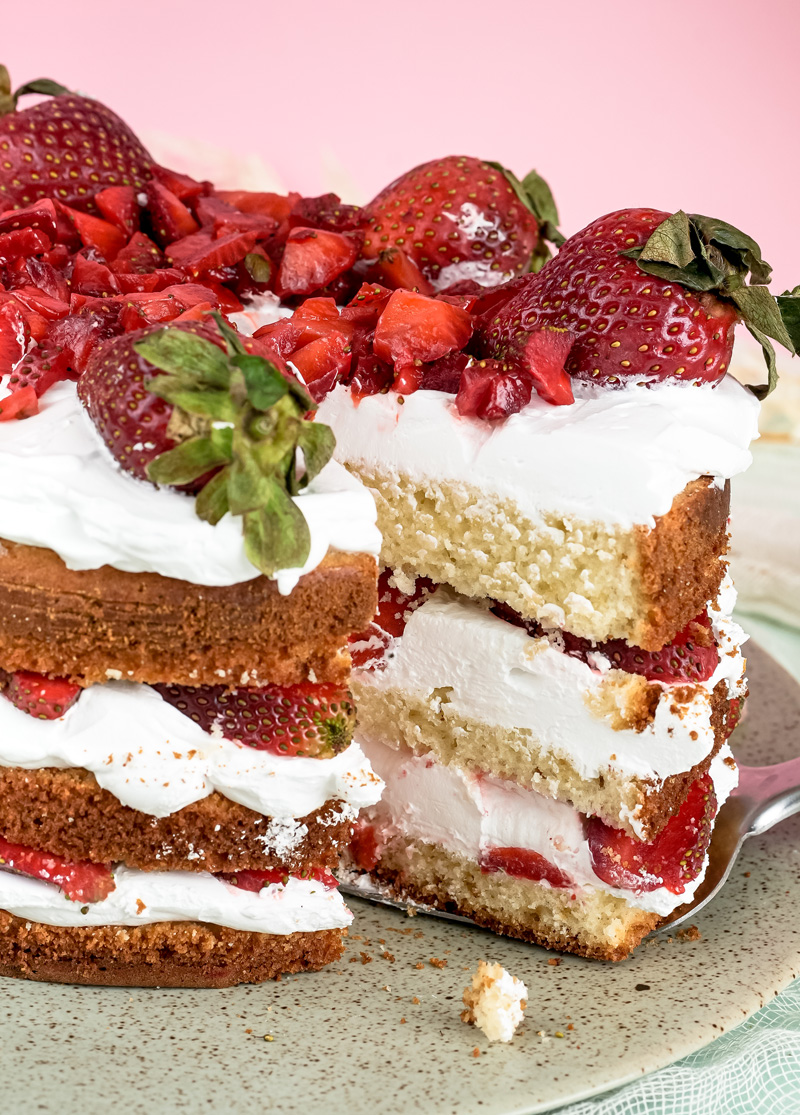 Cut strawberry shortcake slice showing internal layers and fresh berries
