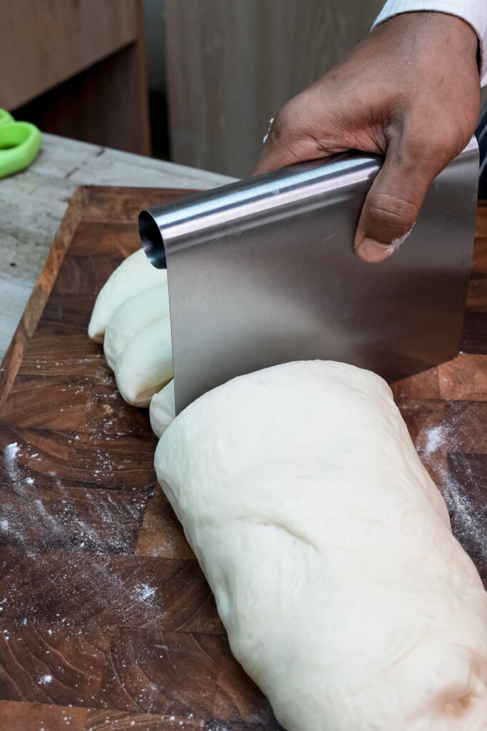Cutting bun dough with bench scraper