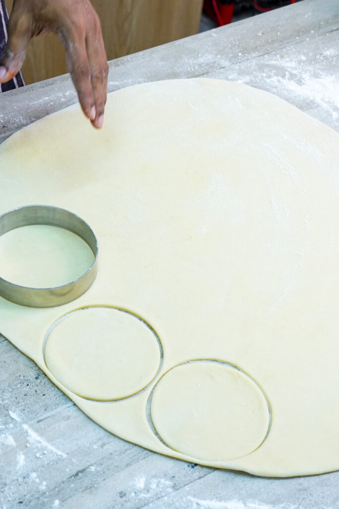 Cutting empanada dough circles with round cutter